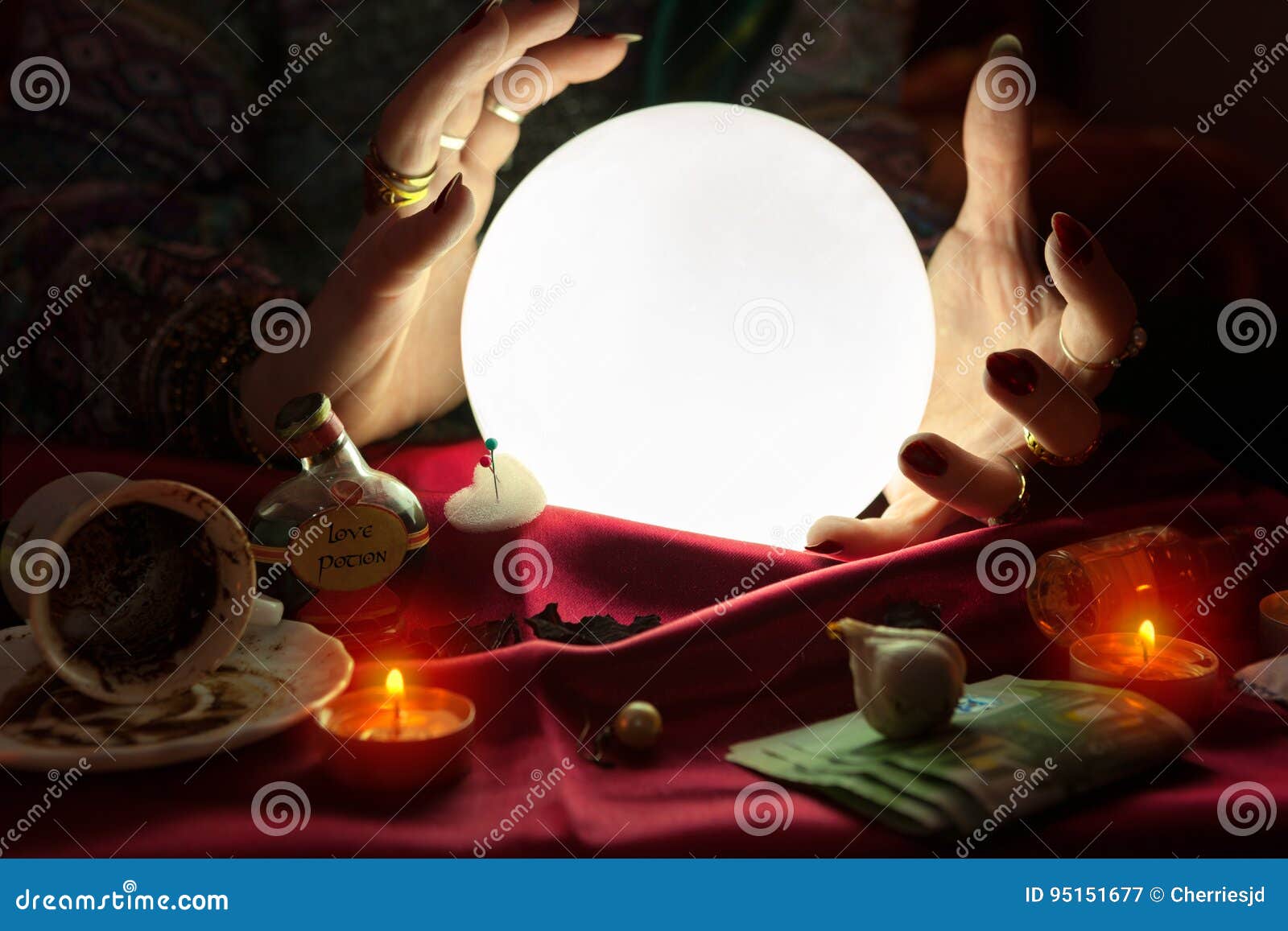 Hands of Fortune Teller Around Illuminated Crystal Ball Stock Image