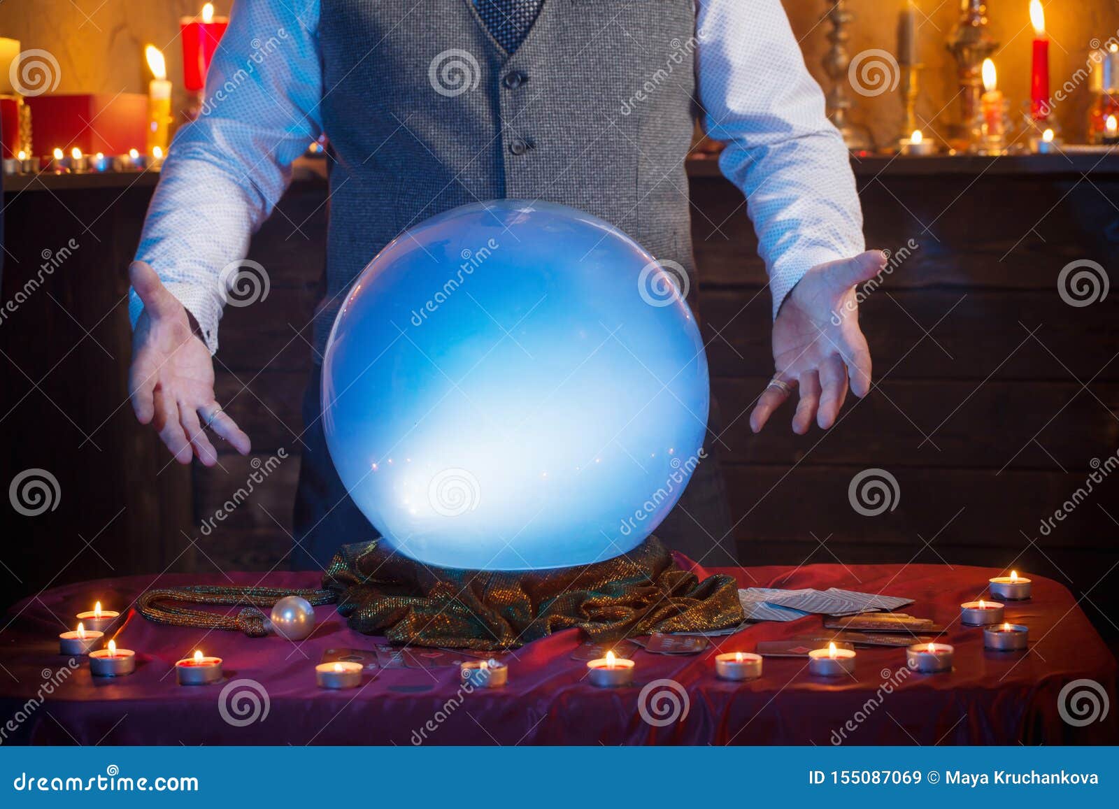 Hands of Fortune Teller with Illuminated Crystal Ball Stock Image