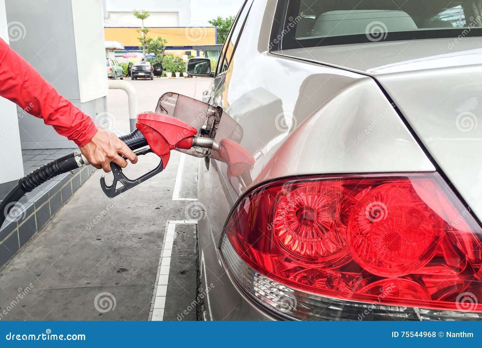 Hands fueling gas the car stock photo. Image of hold 75544968