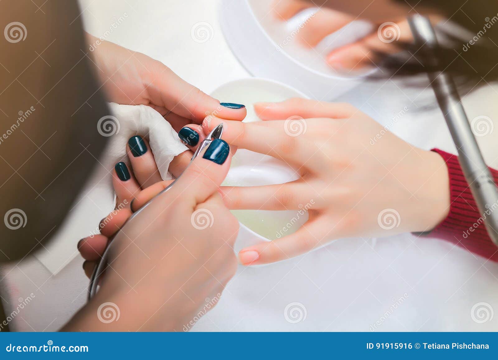 Hands of the Girl in the Baths with Water during a Manicure, Cleansing the Cuticle Stock Photo