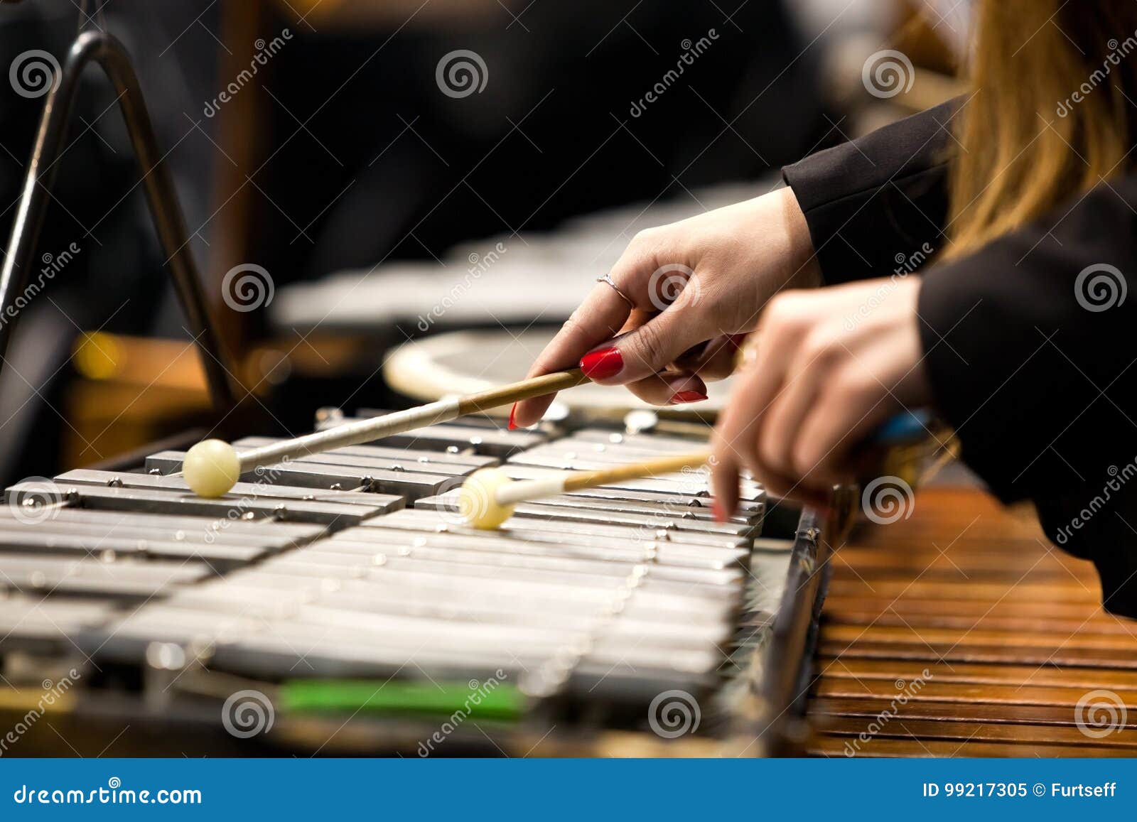 Hands of a girl playing a glockenspiel closeup