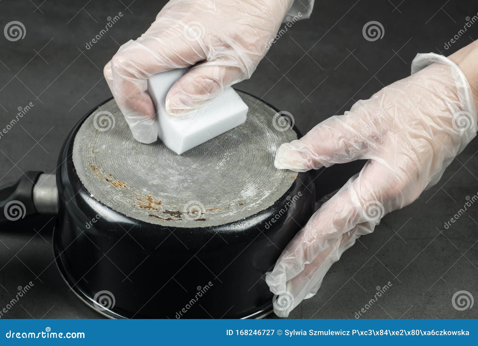hands in gloves cleaning old pot with eco friendly magic sponge