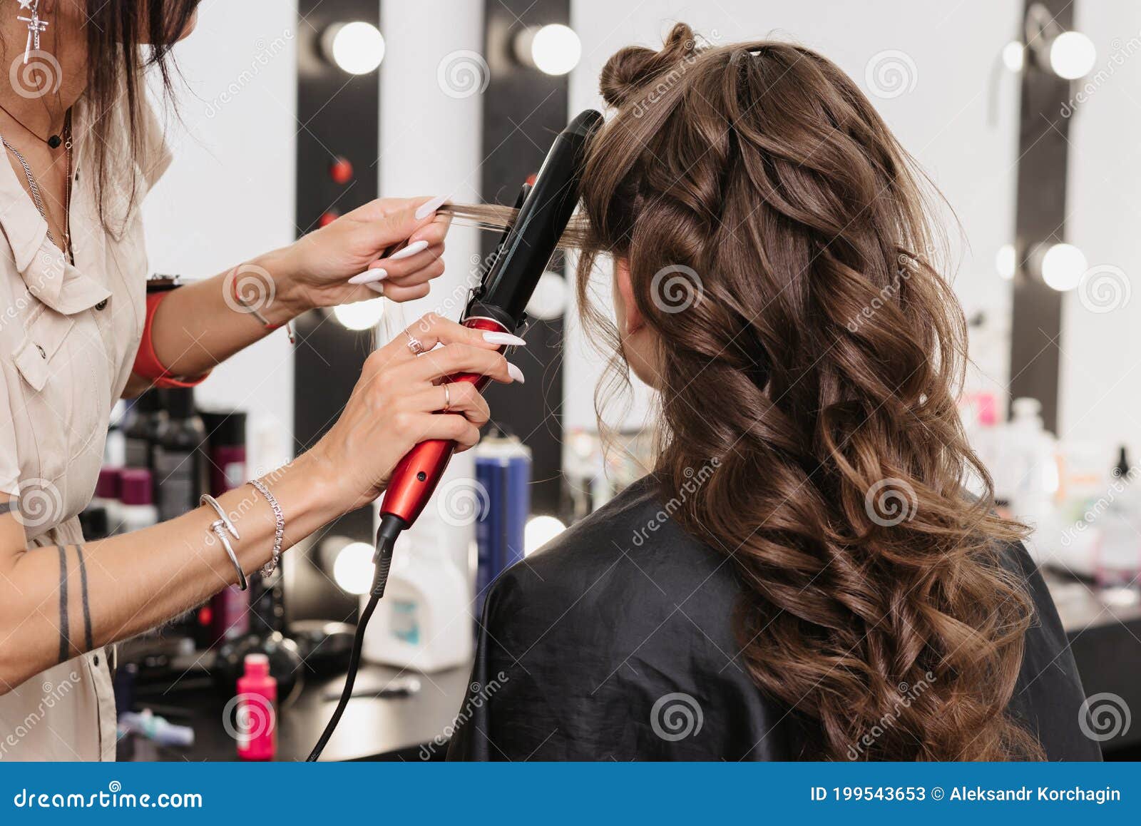 Hands of a Hairdresser with a Curling Iron Making a Hairstyle for a Curly  Girl Stock Image - Image of curls, hairstyling: 199543653