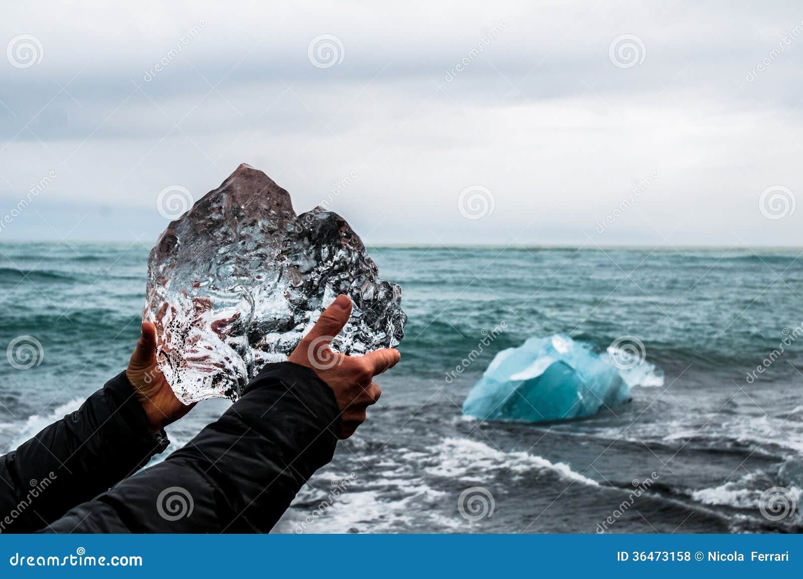 hands holding a block of pristine glacier ice