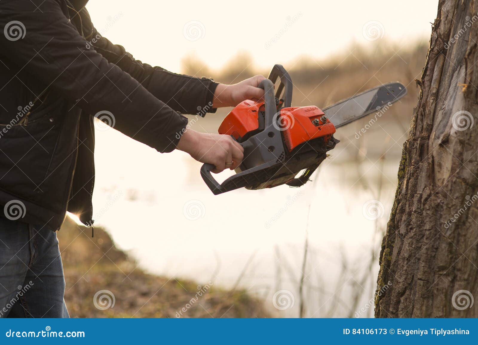 Hands holding a chainsaw stock image. Image of wood, machine 84106173