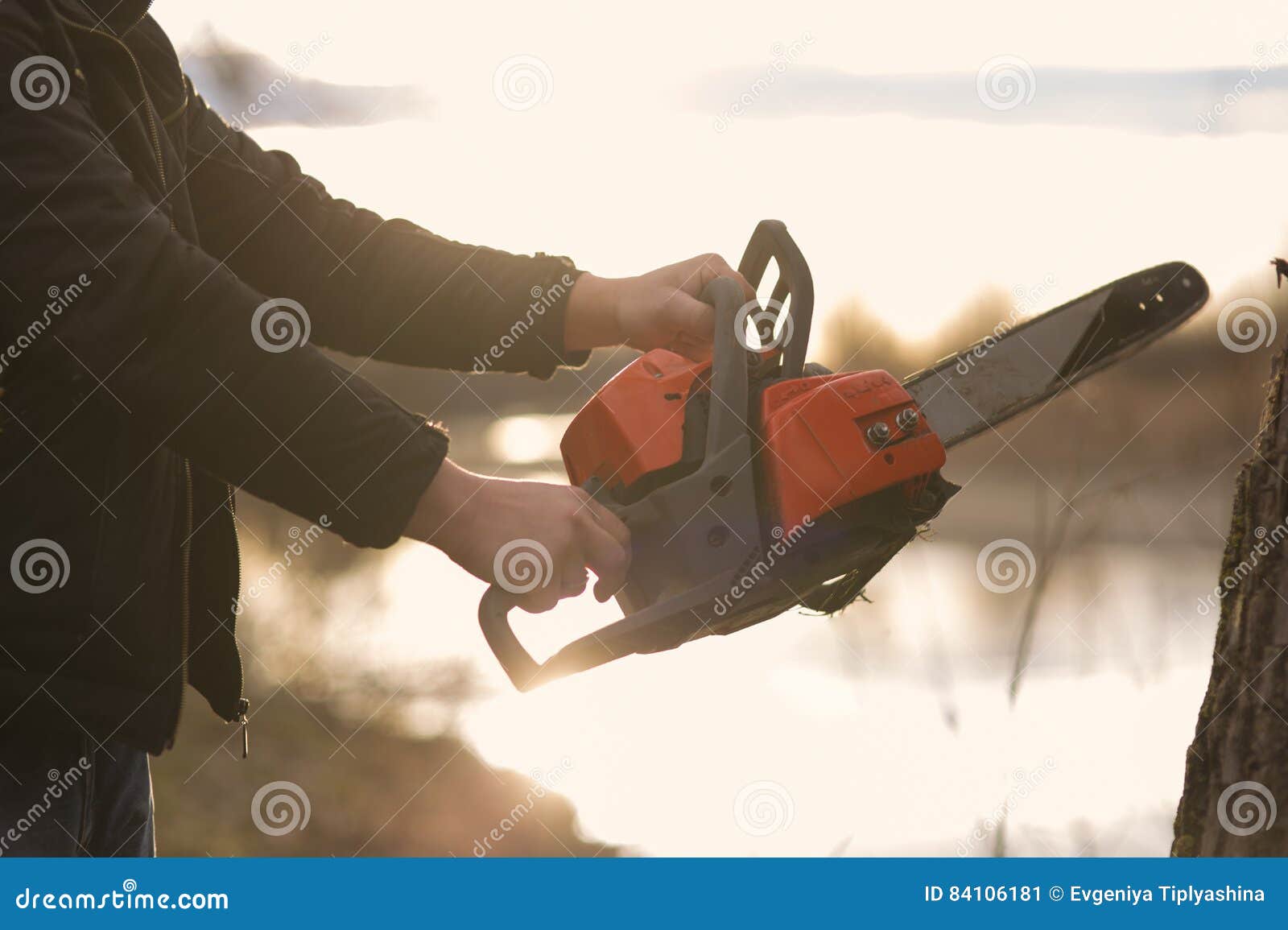 Hands holding a chainsaw stock image. Image of power 84106181