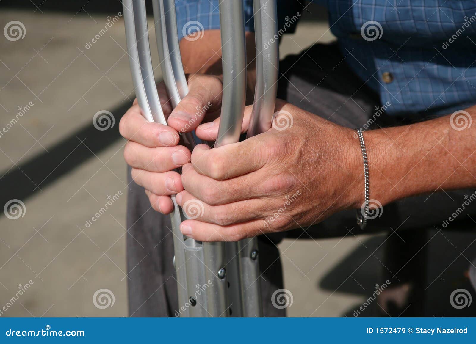 hands holding crutches