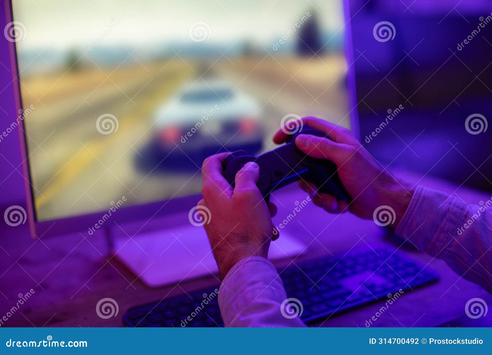 hands holding a game controller before a screen