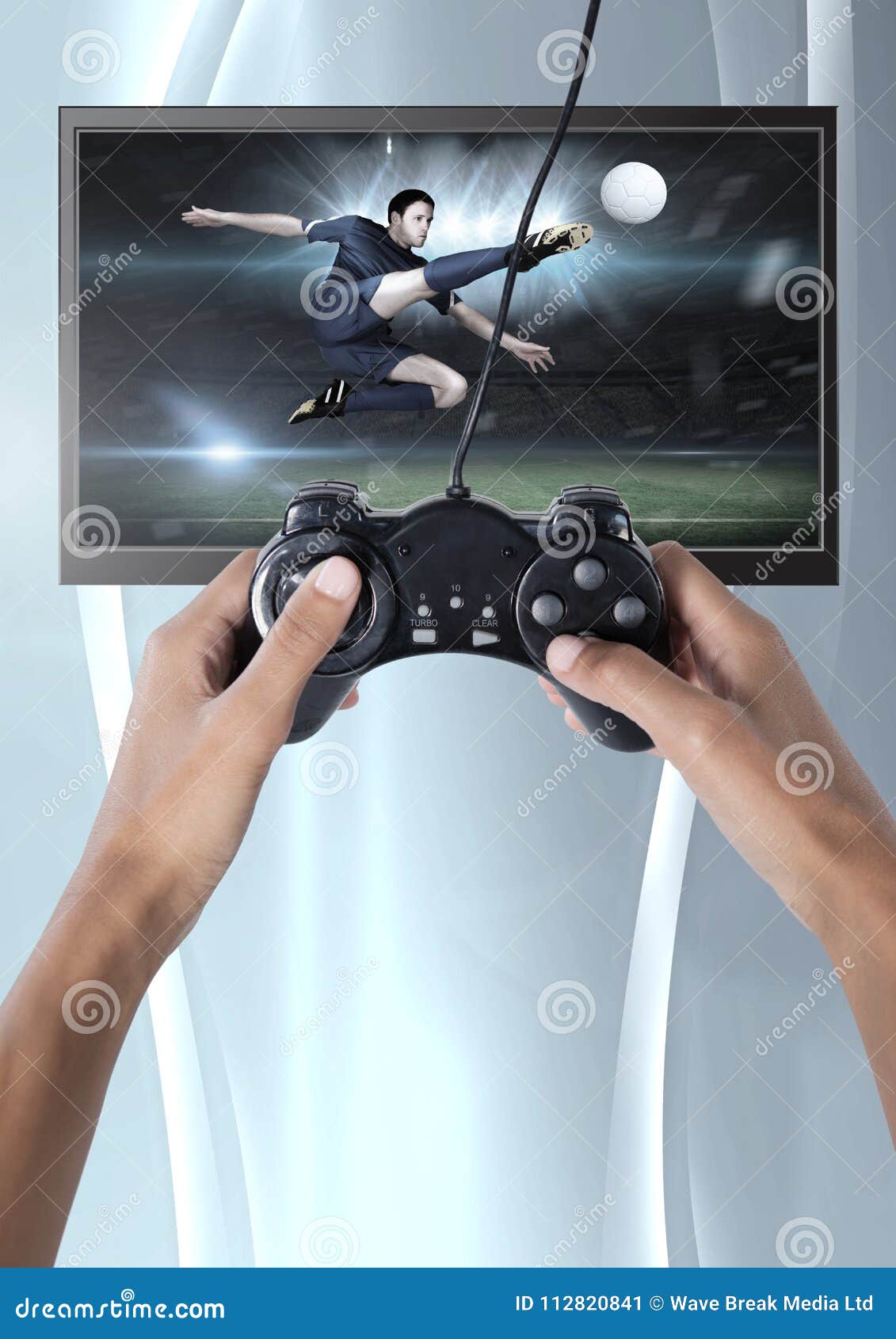 Hands Holding Gaming Controller with Soccer Player on Television Stock