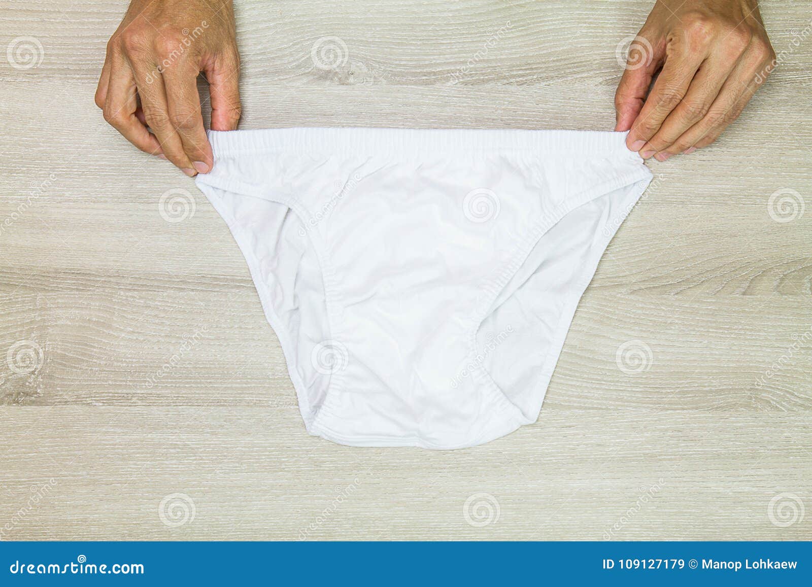 https://thumbs.dreamstime.com/z/hands-holding-men-clean-white-underwear-vintage-wooden-background-109127179.jpg