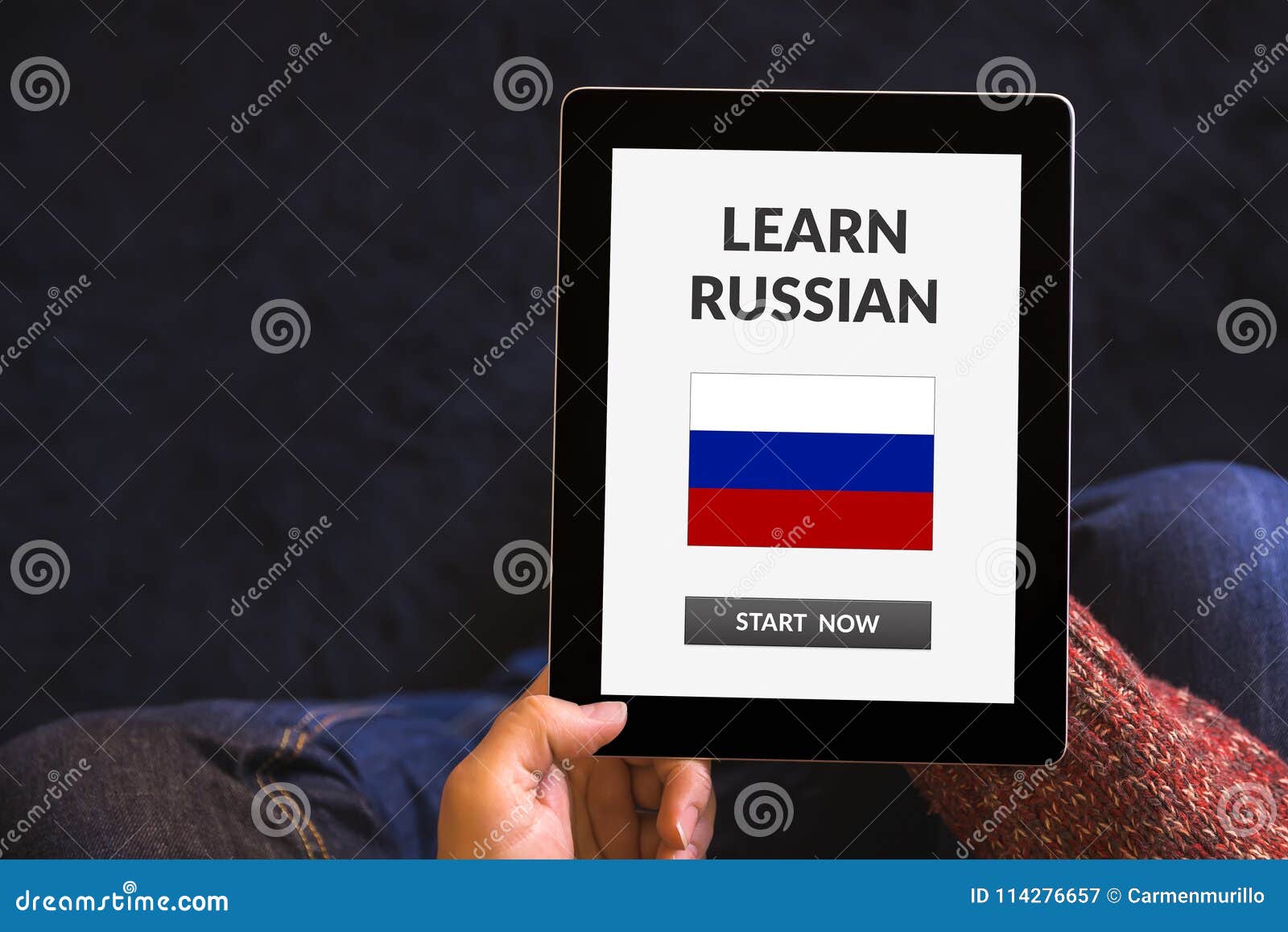 Hands Holding Tablet with Learn Russian Concept on Screen Stock Image