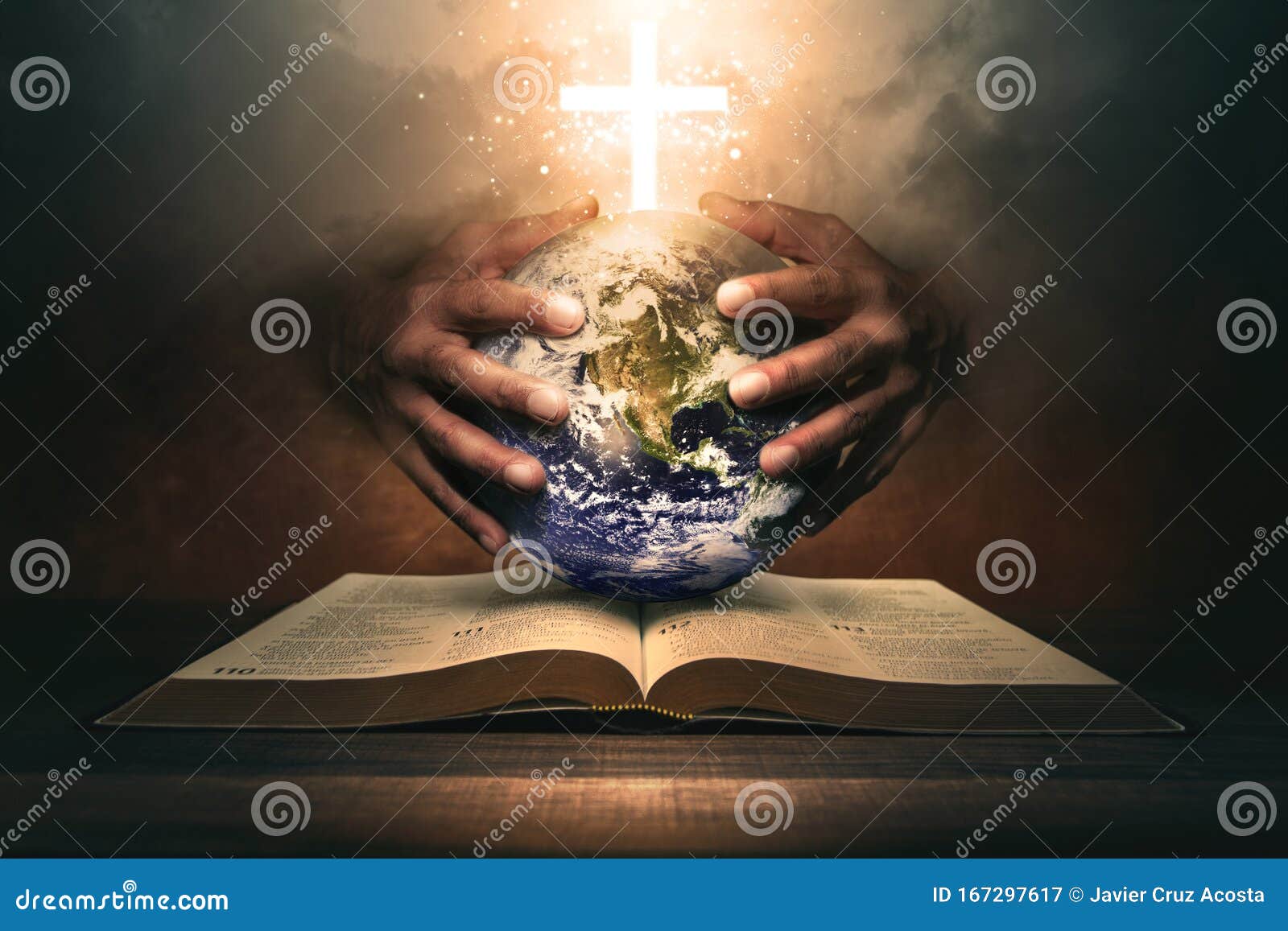 hands holding the world on a holy bible