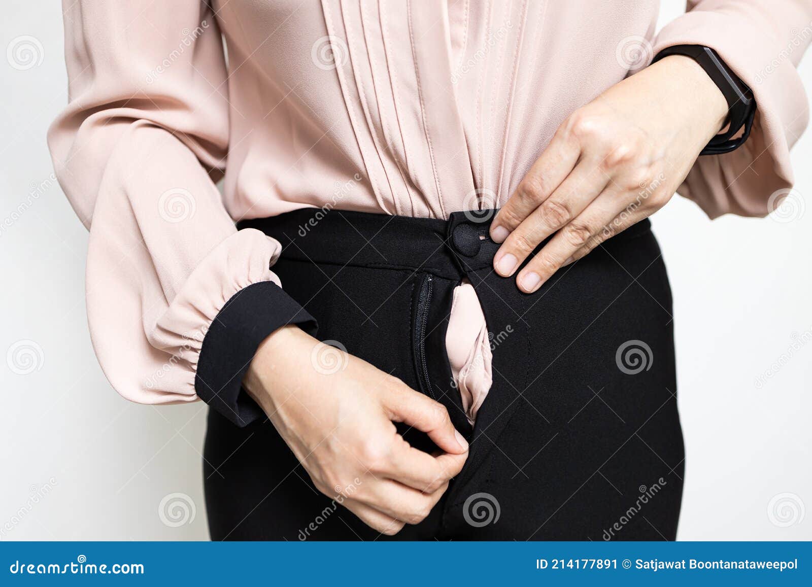 hands of lady girl trying to zipping up her pants,try to close her tight pants with difficult from fat,weight gain,overweight or