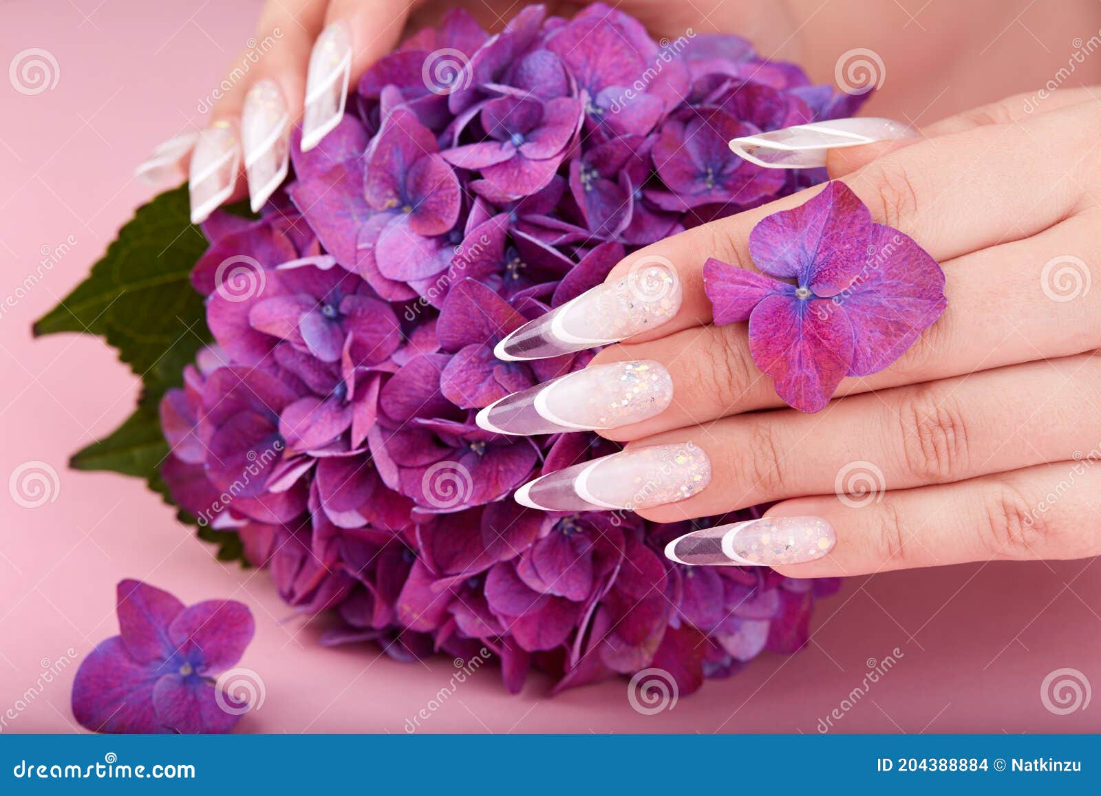 hands with long artificial french manicured nails