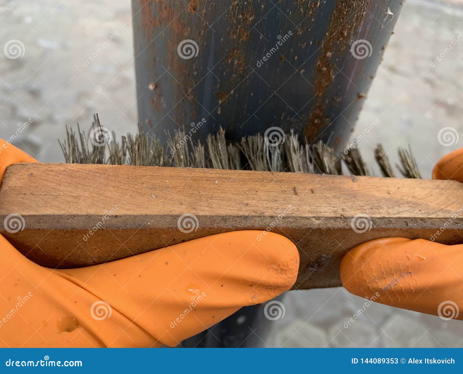Hands Man with Brush Metal Sanding a Piece of Metal. Closeup. Stock