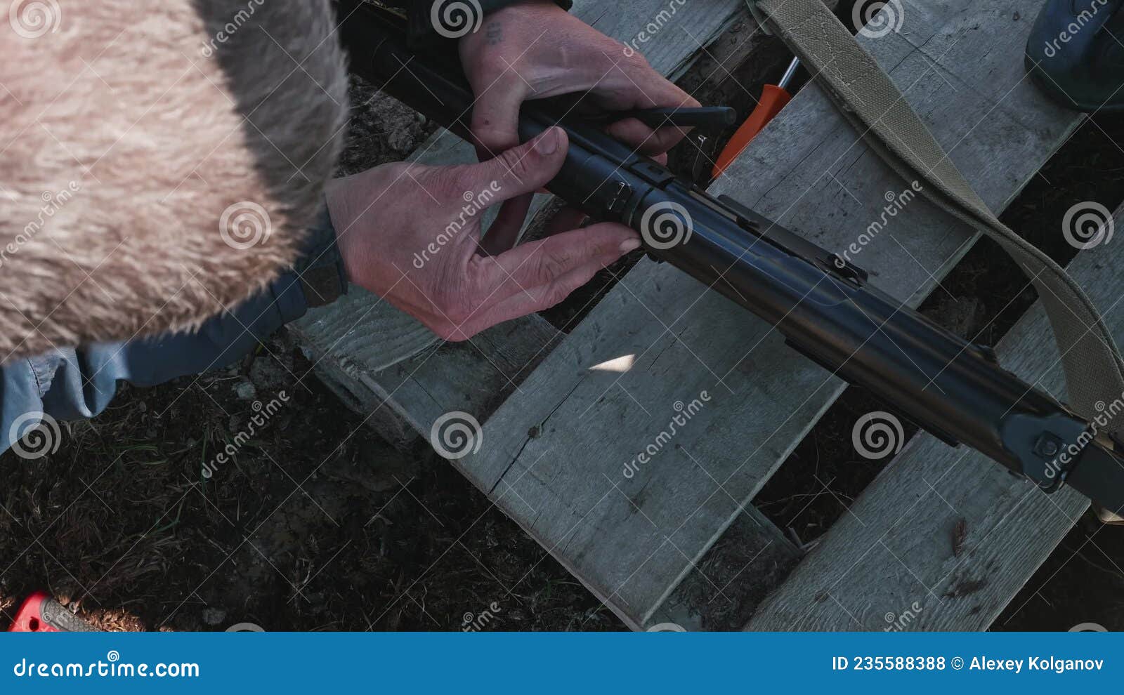 Hands of Man Using Hammer To Calibrate Gun. Preparation for Hunting