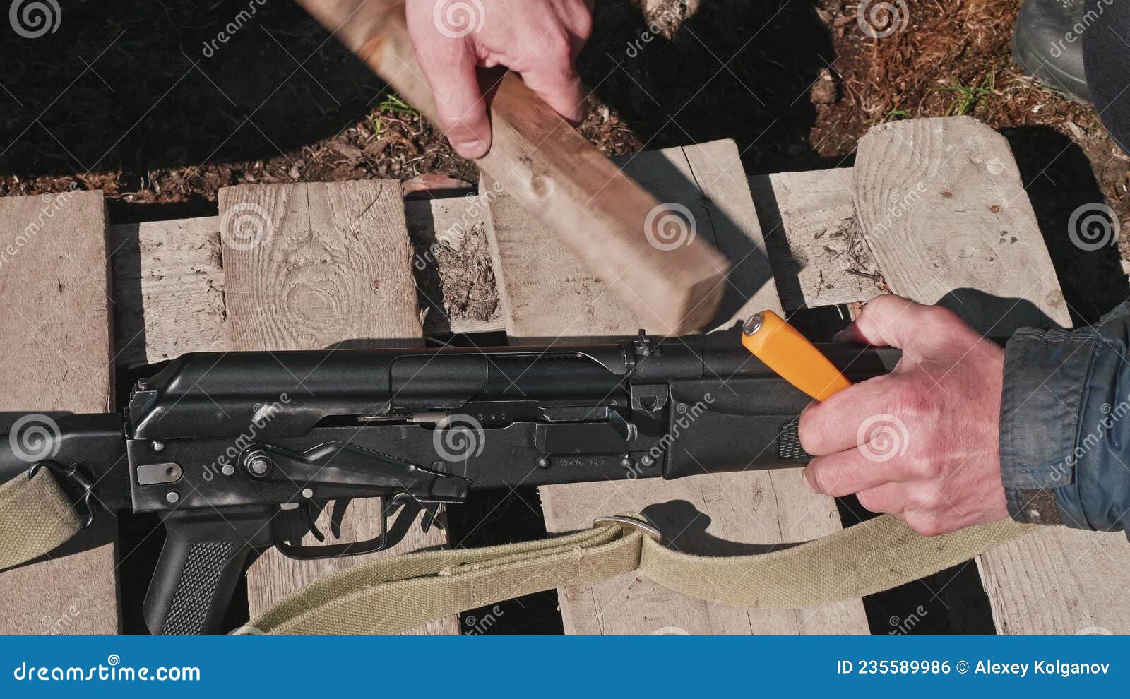 Hands of Man Using Hammer To Calibrate Gun. Preparation for Hunting