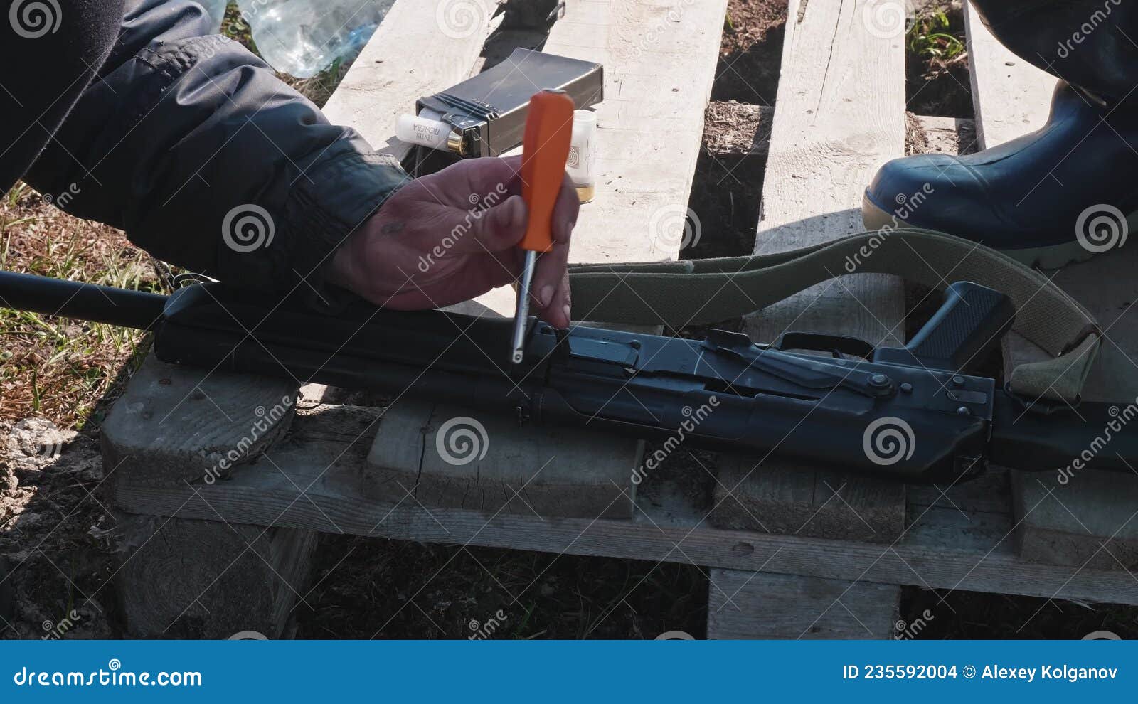 Hands of Man Using Hammer To Calibrate Gun. Preparation for Hunting