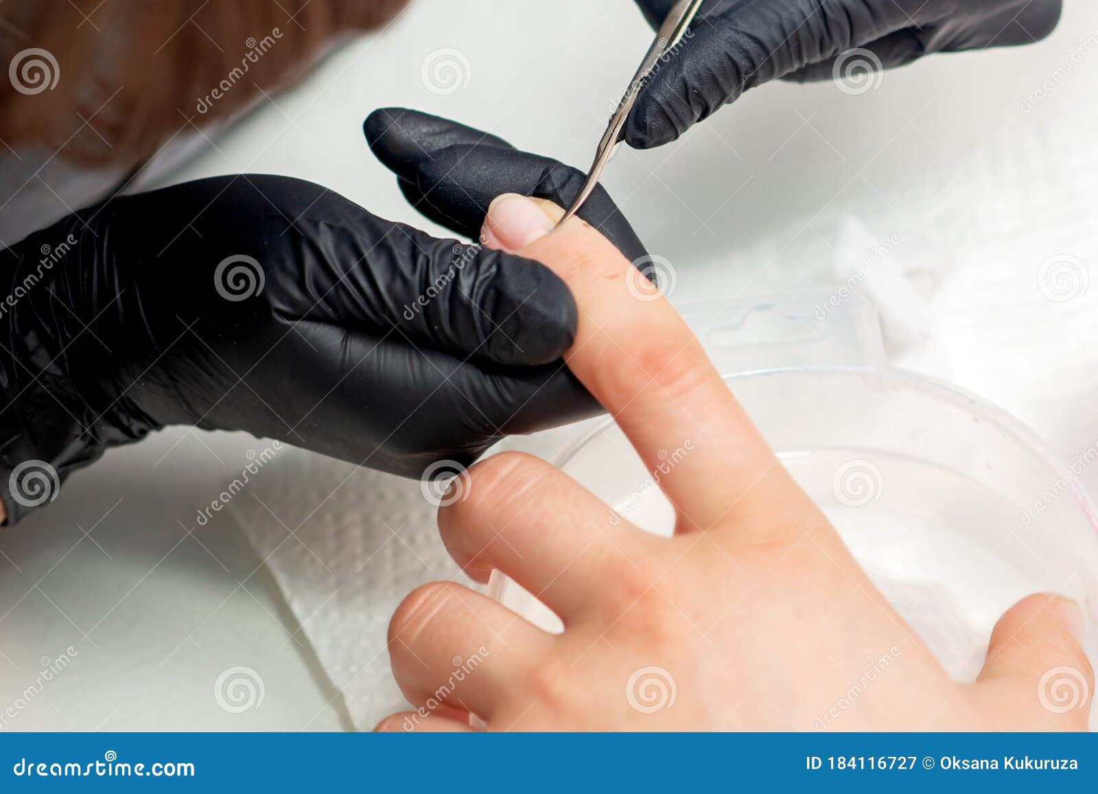 beautician cutting cuticles of woman