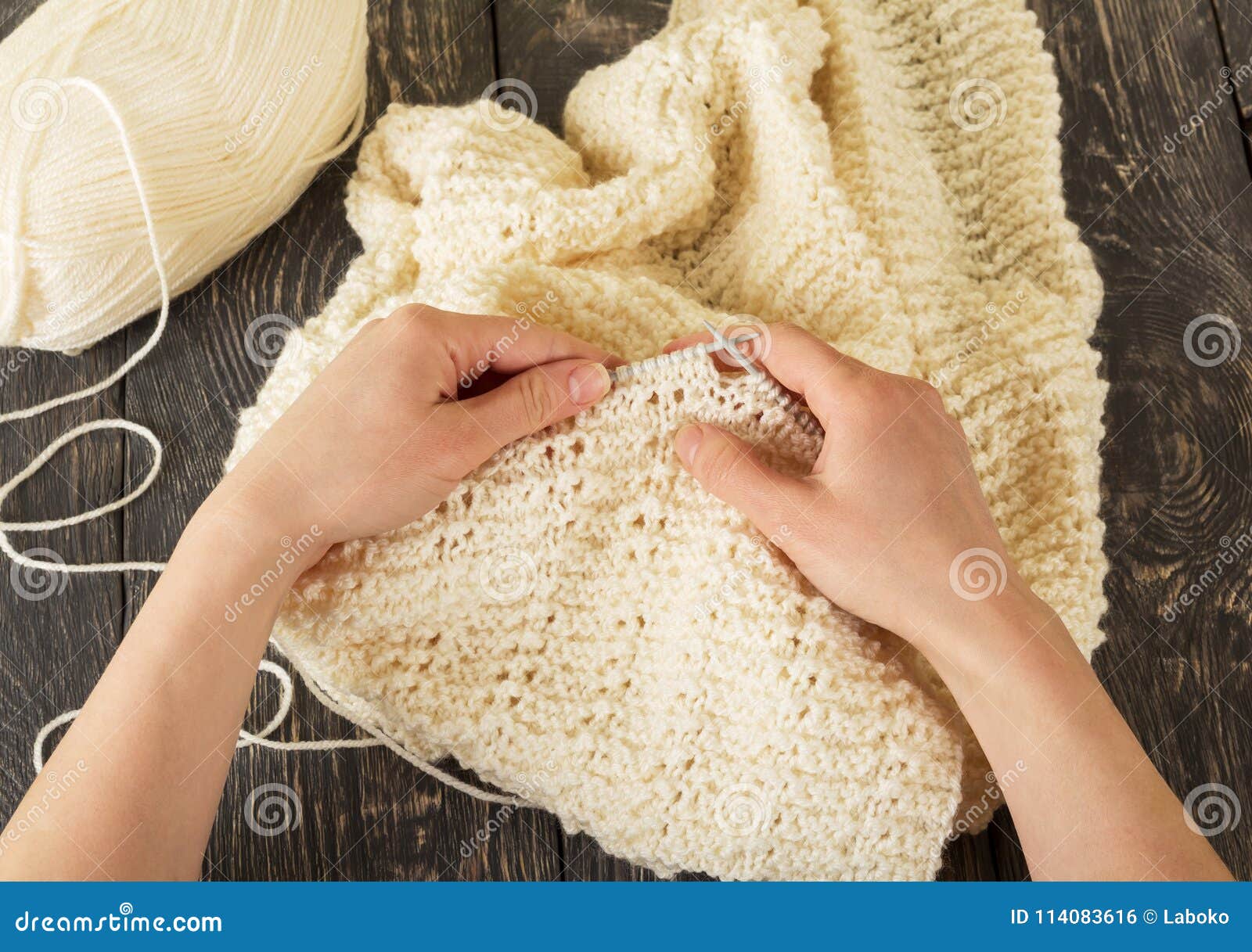 Hands of Master at Work, Yarn, Knitting Needles and the Finished