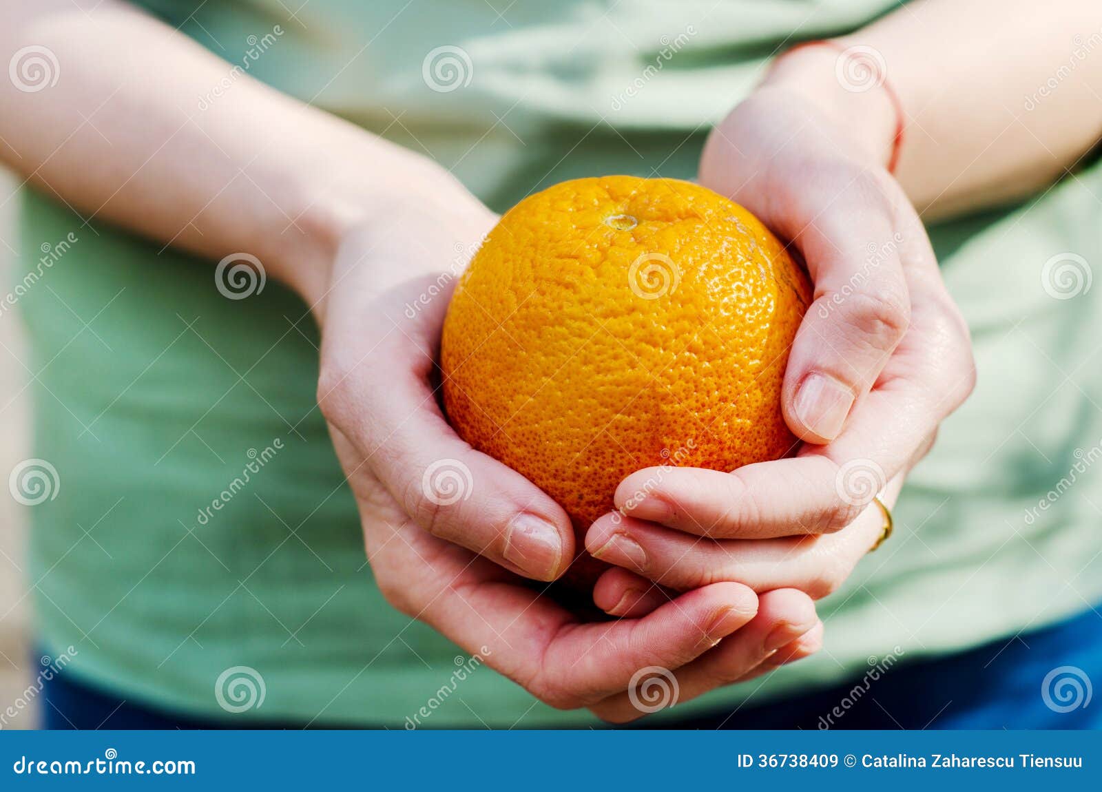 Hands with orange stock image. Image of blue, warm, denim 36738409