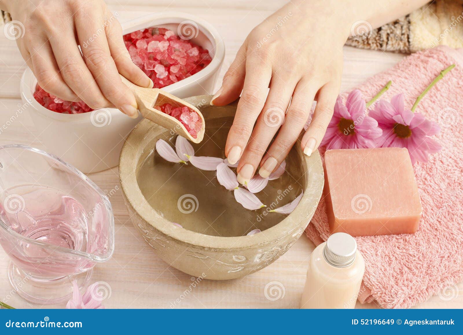 Hands Over Ceramic Bowl with Water and Essential Oils Stock Image