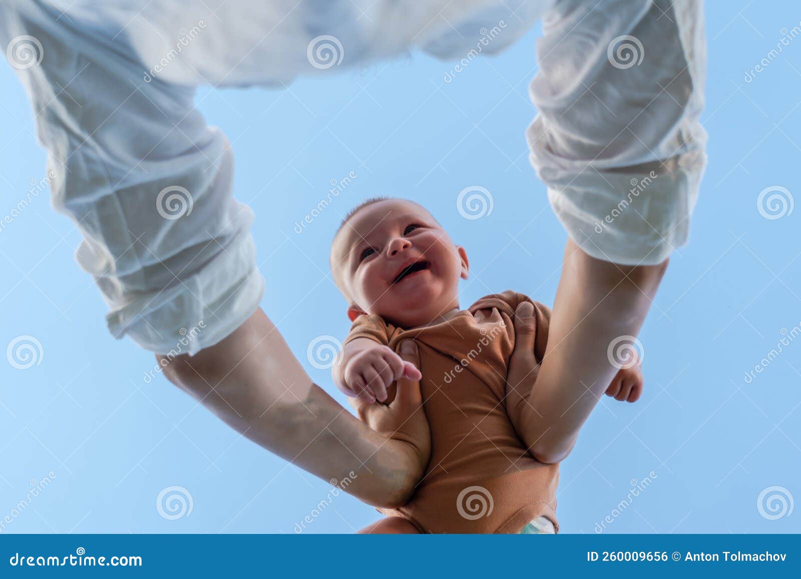 Hands of Parent Picking Up a Happy Baby Stock Photo Image of leisure