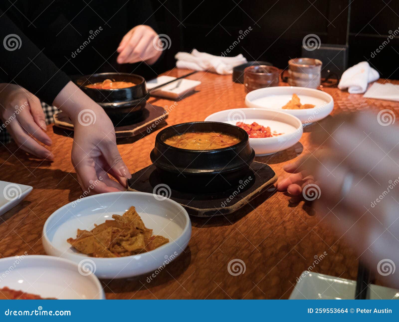 Hands Picking at Side Dishes in a Korean Restaurant Stock Photo Image