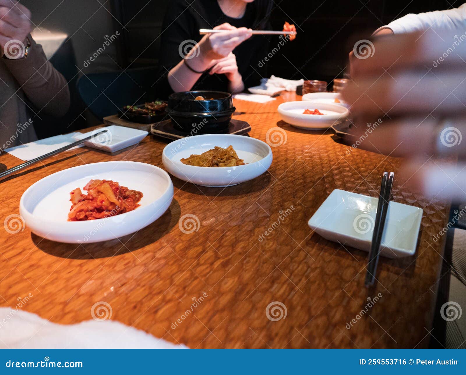 Hands Picking at Side Dishes in a Korean Restaurant Stock Photo Image