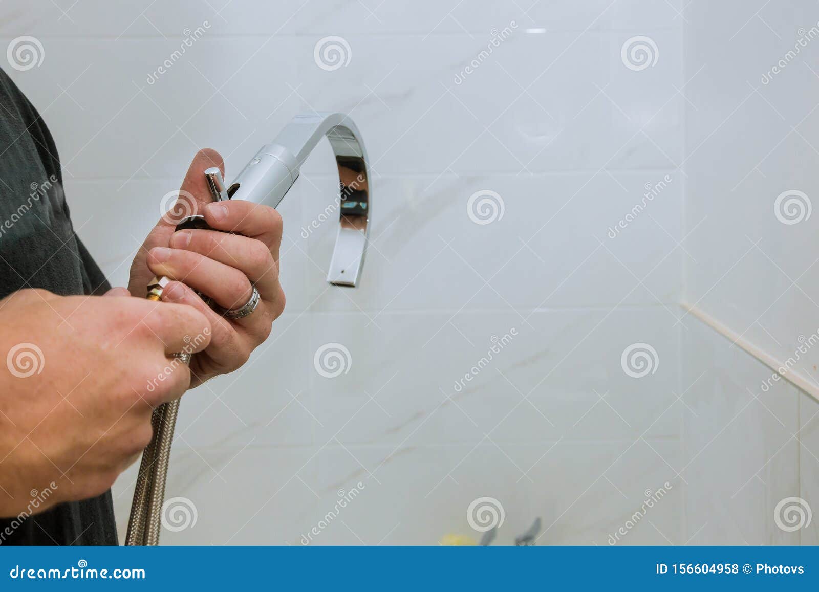 Hands Plumber At Work In A Bathroom Installation Of Faucet Stock