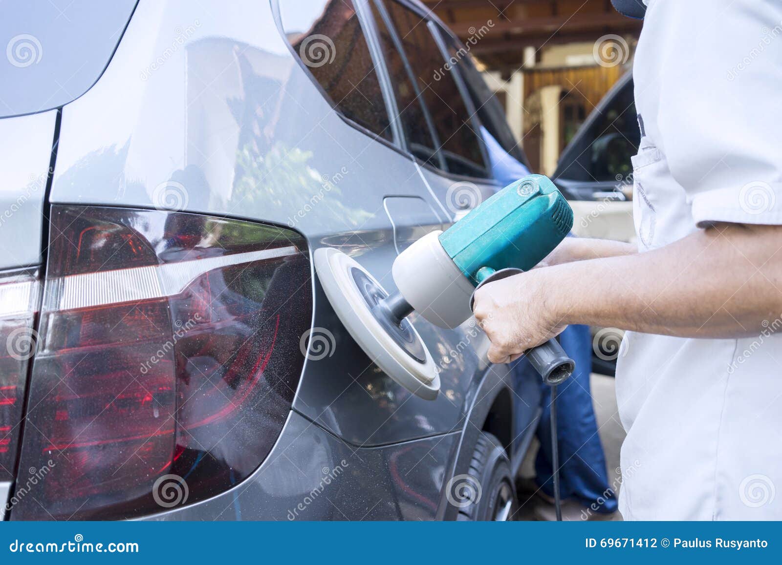 hands polishing car with auto polisher