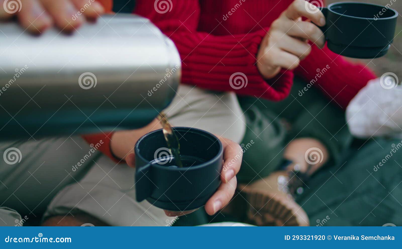 Close-up of Man Holding Thermos and an Iron Mug, Pouring Hot Tea