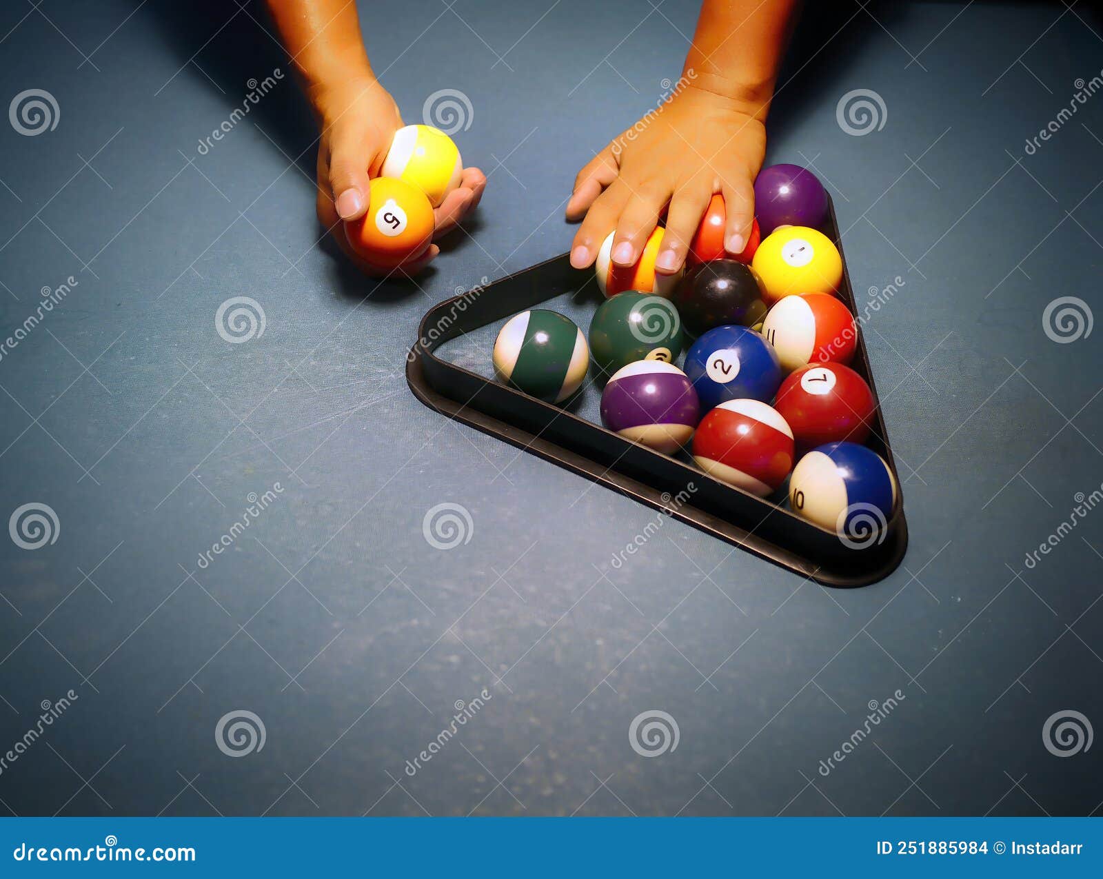 Hands Preparing Pool Balls in Triangle Rack on the Billiard Table Stock