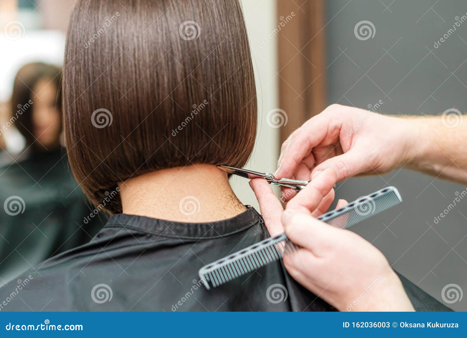 Hands Of Professional Hair Stylist Is Cuting Hair Tips With