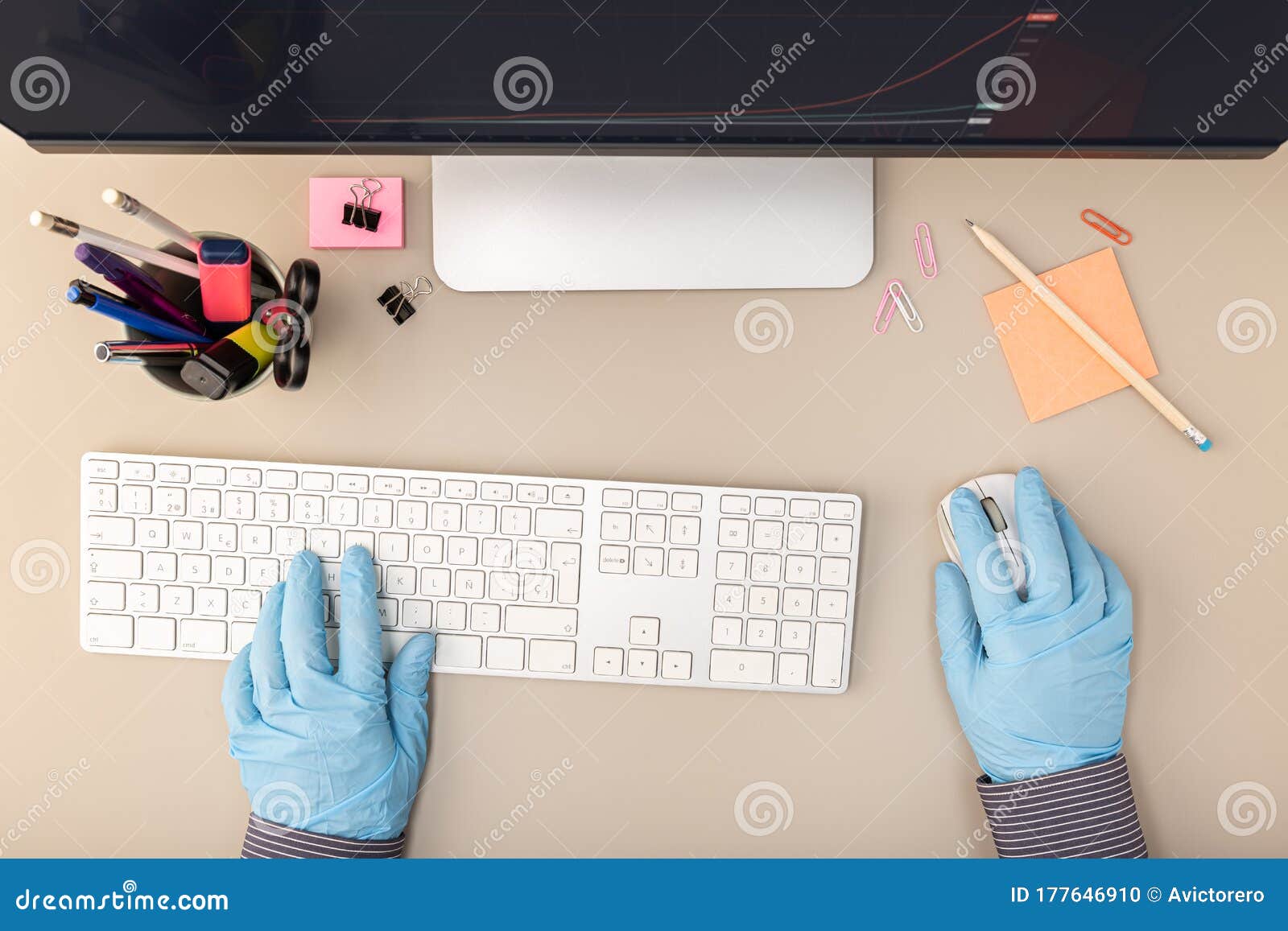 Hands with Protective Glove Typing on Keyboard Computer Stock Photo