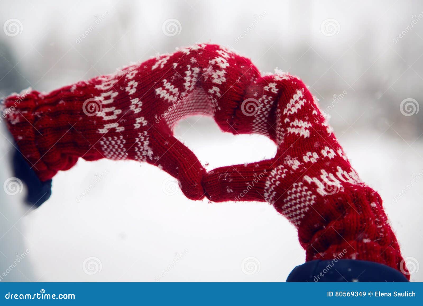 hands in red mittens folded heart