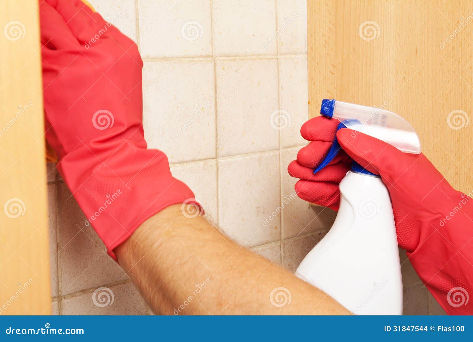 hands in rubber gloves scrubbing bathroom