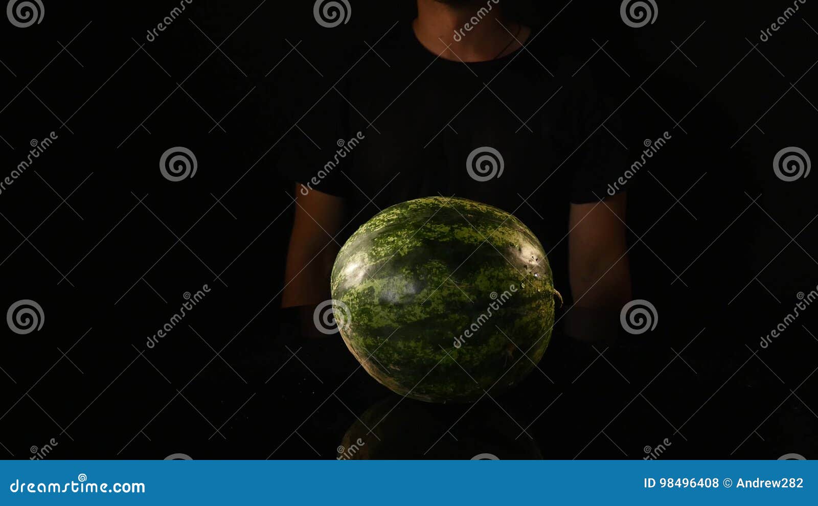 Hands of Scientist Injecting Chemicals into a Watermelon Stock Photo