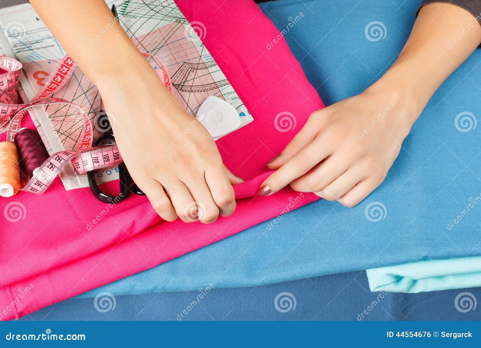 Hands of a Seamstress at Work. Stock Photo Image of blue, hand 44554676
