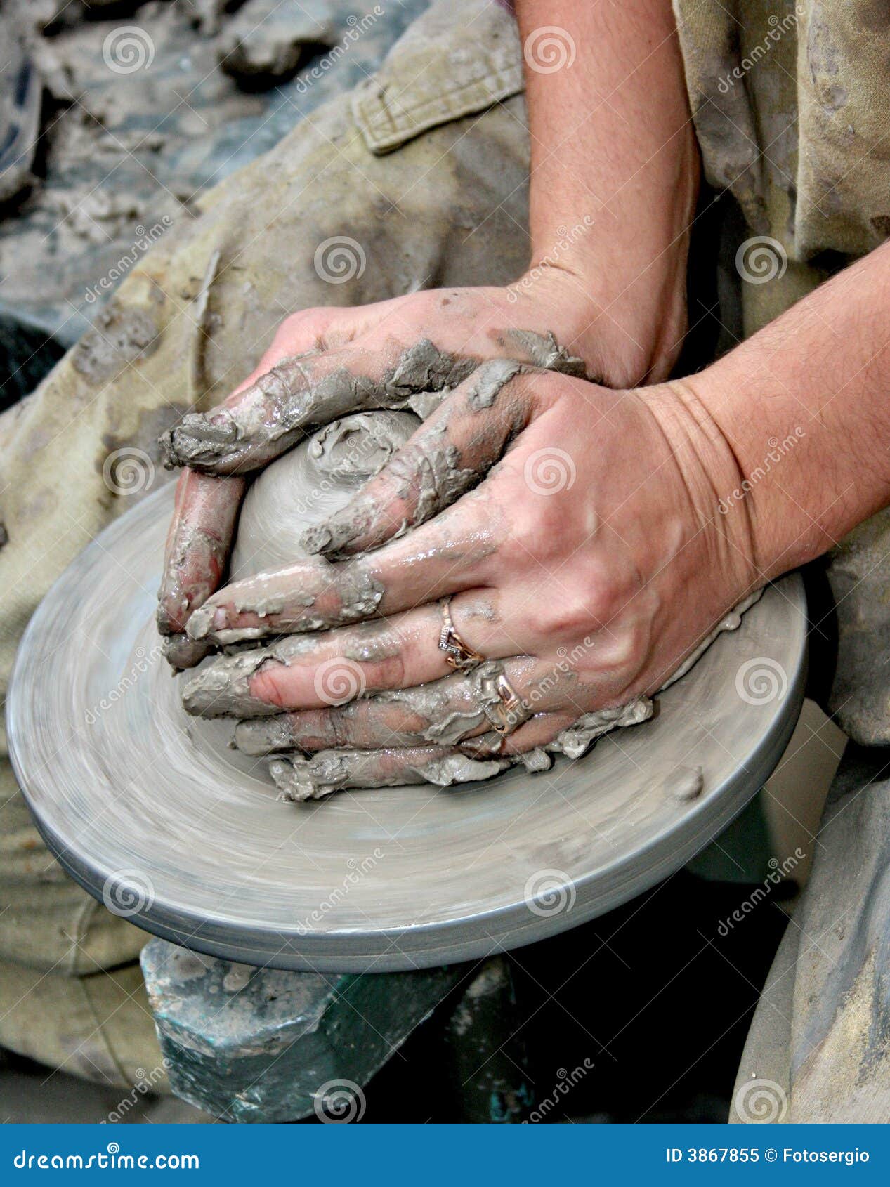 hands shaping clay on potter's wheel