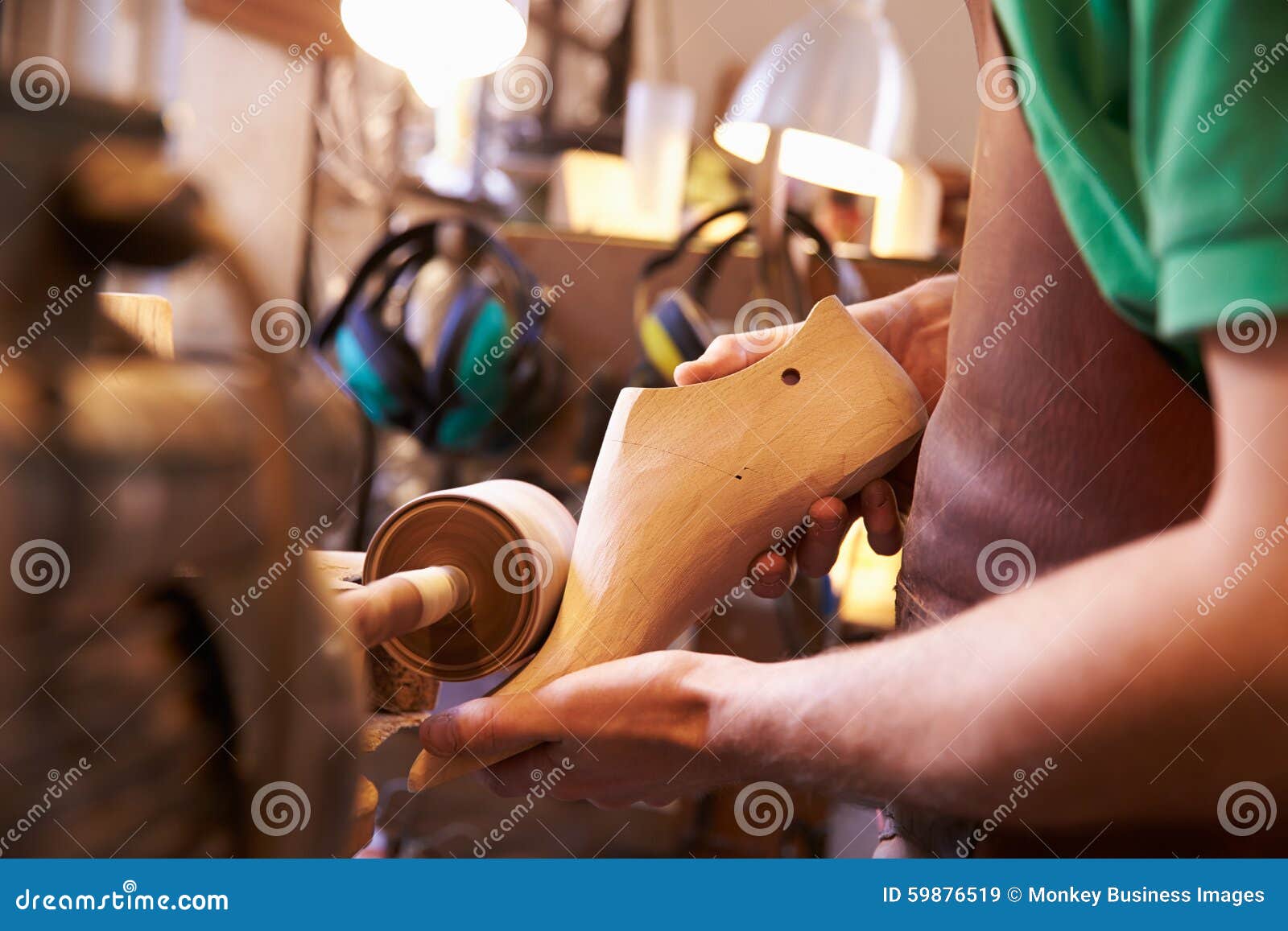 hands of shoemaker shaping shoe lasts in a workshop