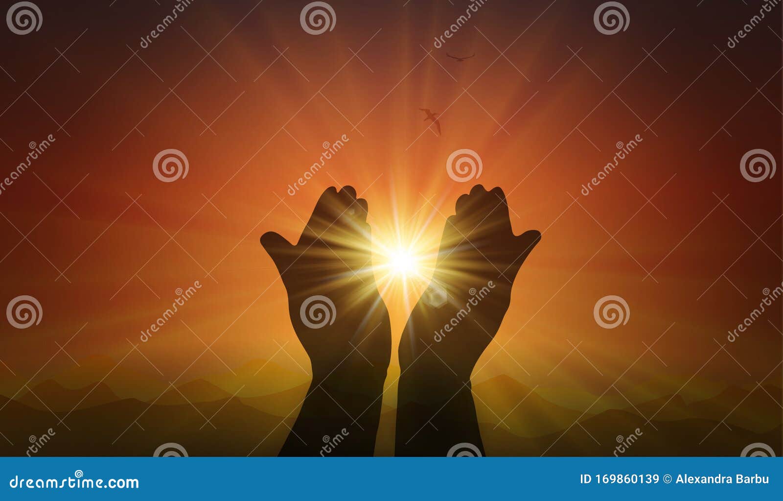 hands with spark of hope, the light of faith, orange sunset background