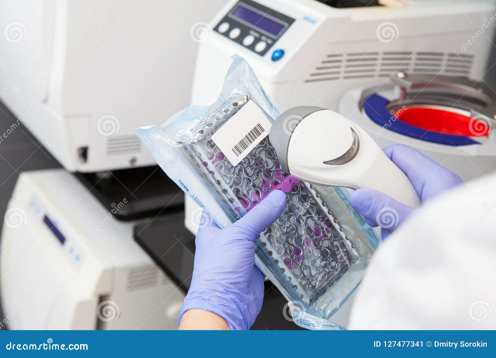 Hands Specialist in Gloves Scans Sterile Dental Instruments Stock Image