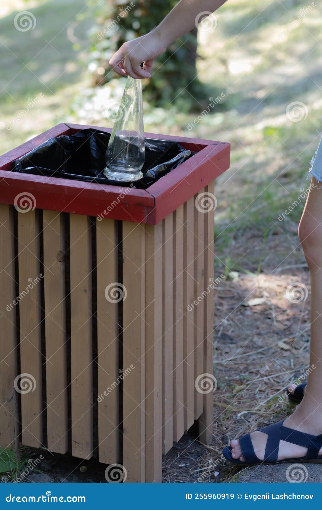 In the Hands of Two Empty Glass Bottles. Throw Away Glassware Stock