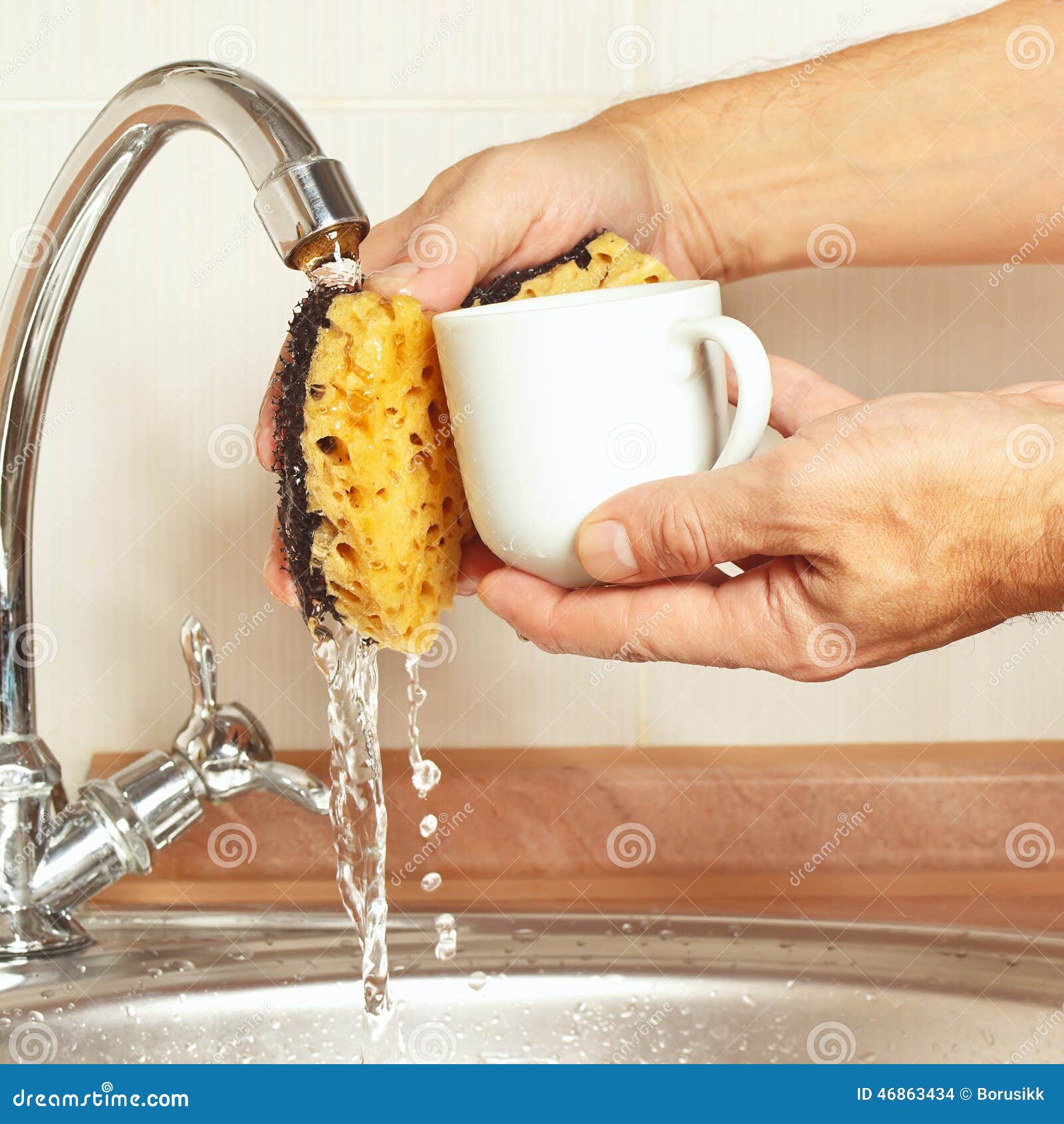 Hands Wash the Coffee Cup Under Running Water in Kitchen Stock Photo