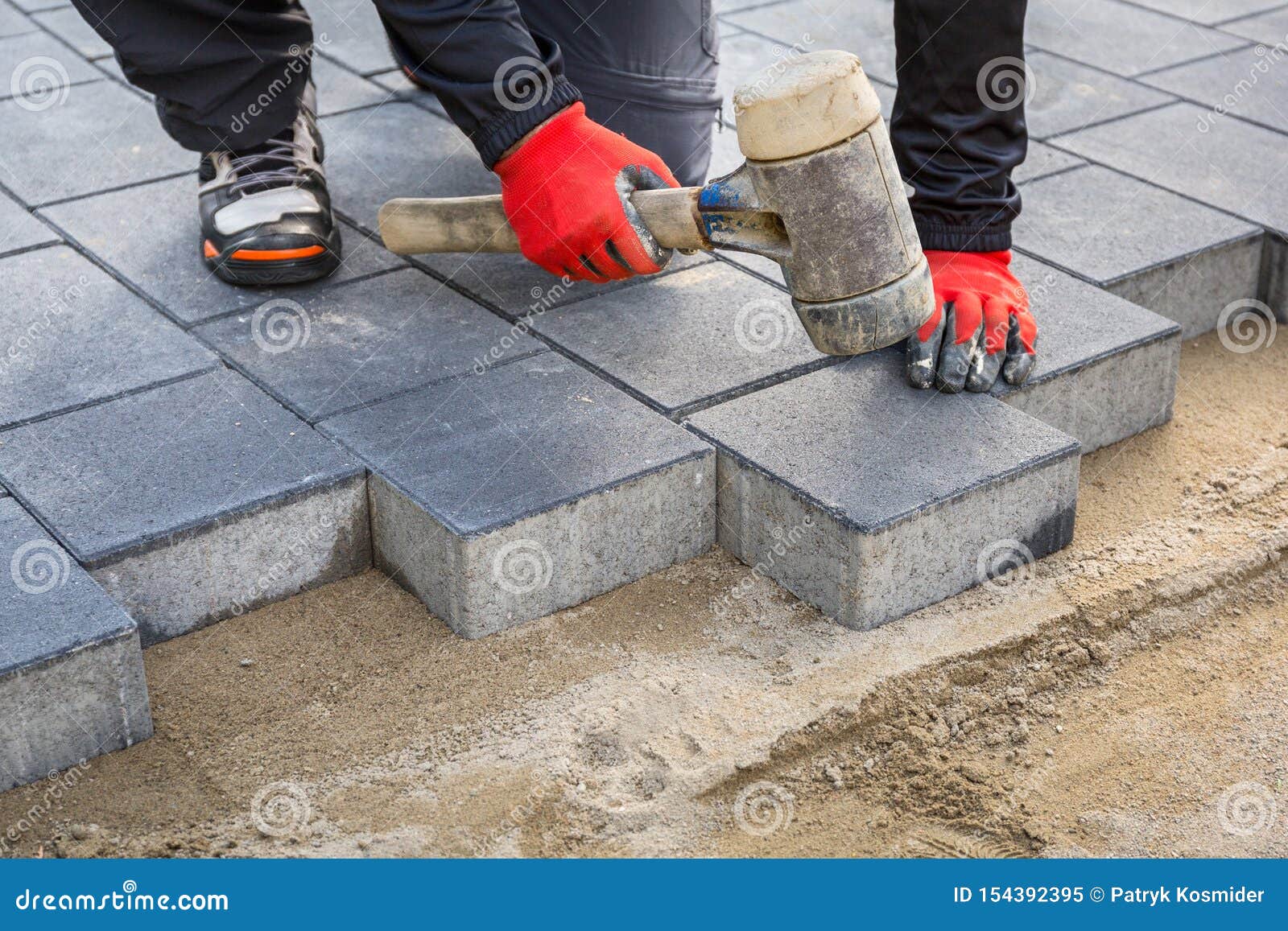Hands Of Worker Installing Concrete Paver Blocks With Rubber Hammer Stock Image Image Of Building Gray 154392395