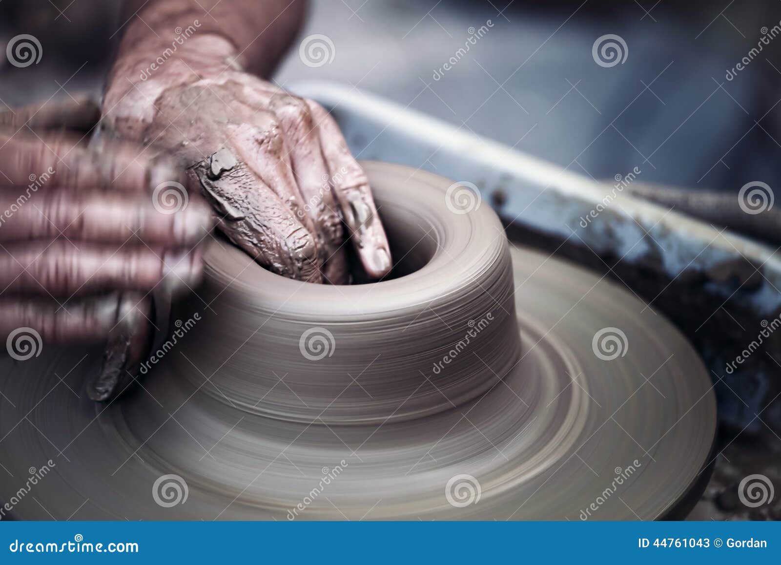 hands working on pottery wheel , artistic toned