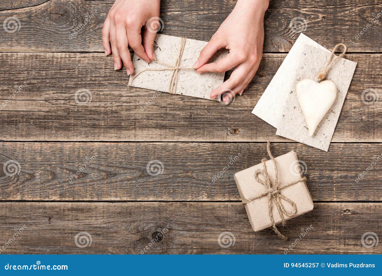 Hands Wrapping Craft Paper Envelope and Gift Box for Present Stock