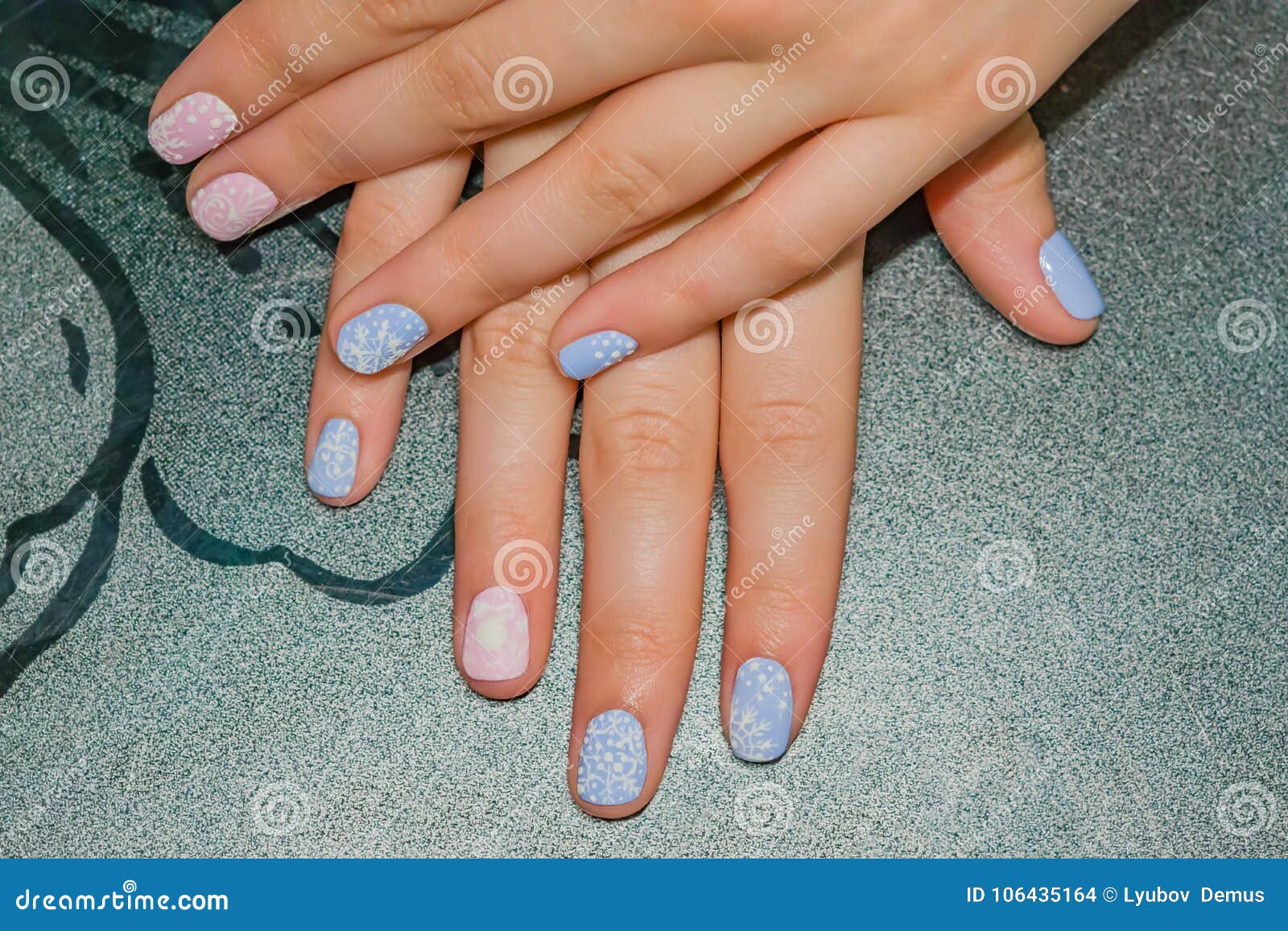 Woman hand with long nails manicure and light pink and blue nail polish  Stock Photo - Alamy