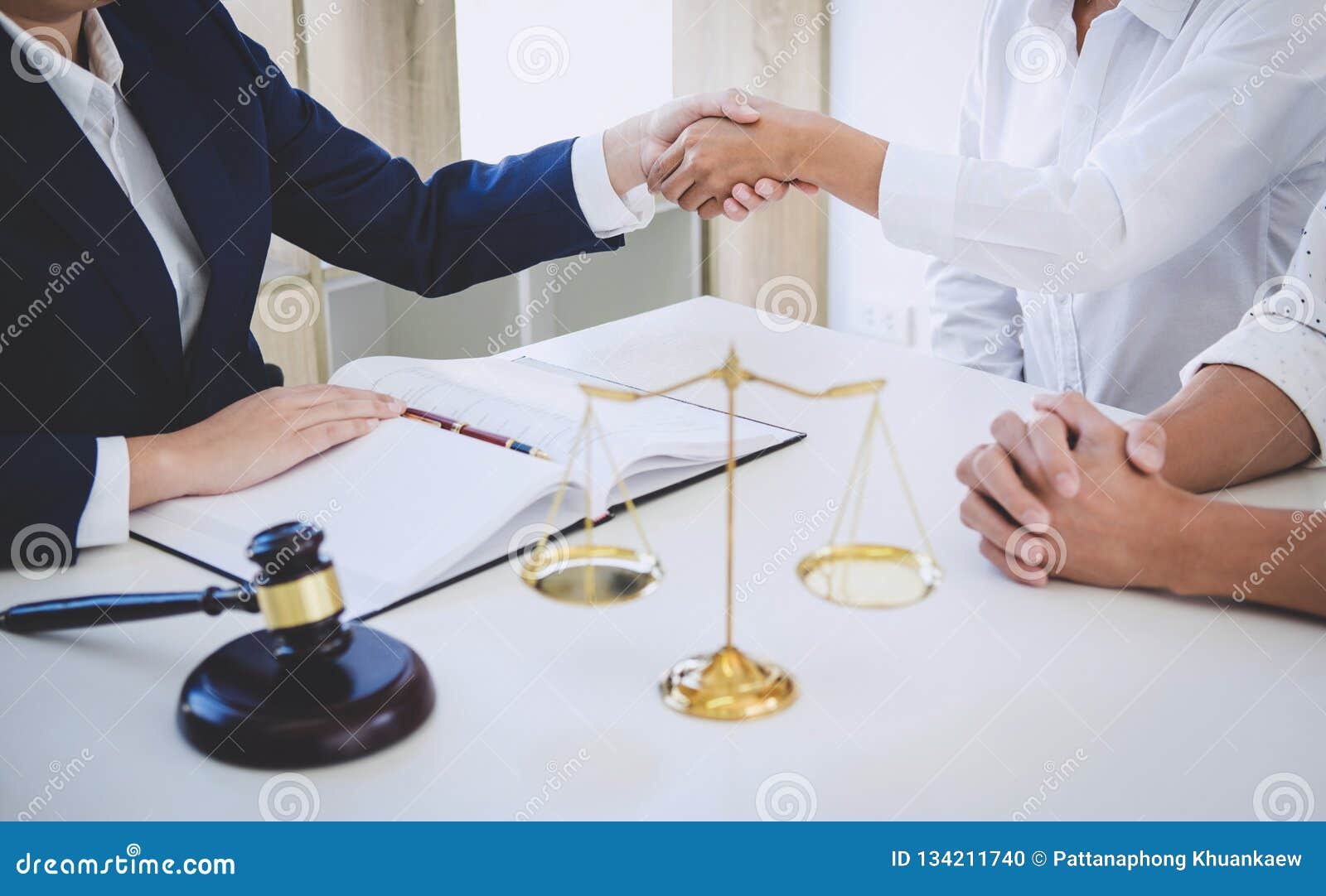 handshake after good cooperation greeting, having meeting with team at law firm, consultation between a female lawyer and